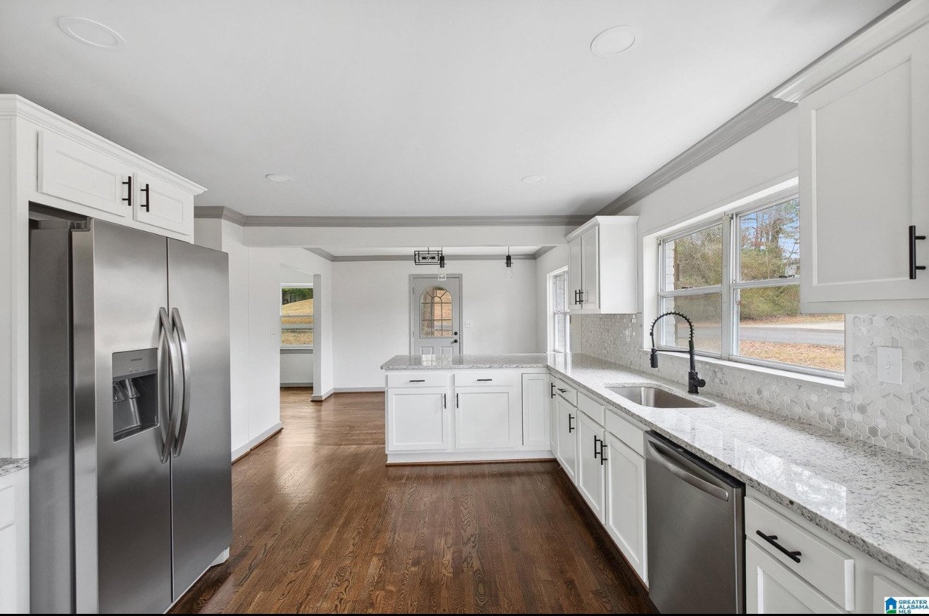 A bright kitchen with white cabinets