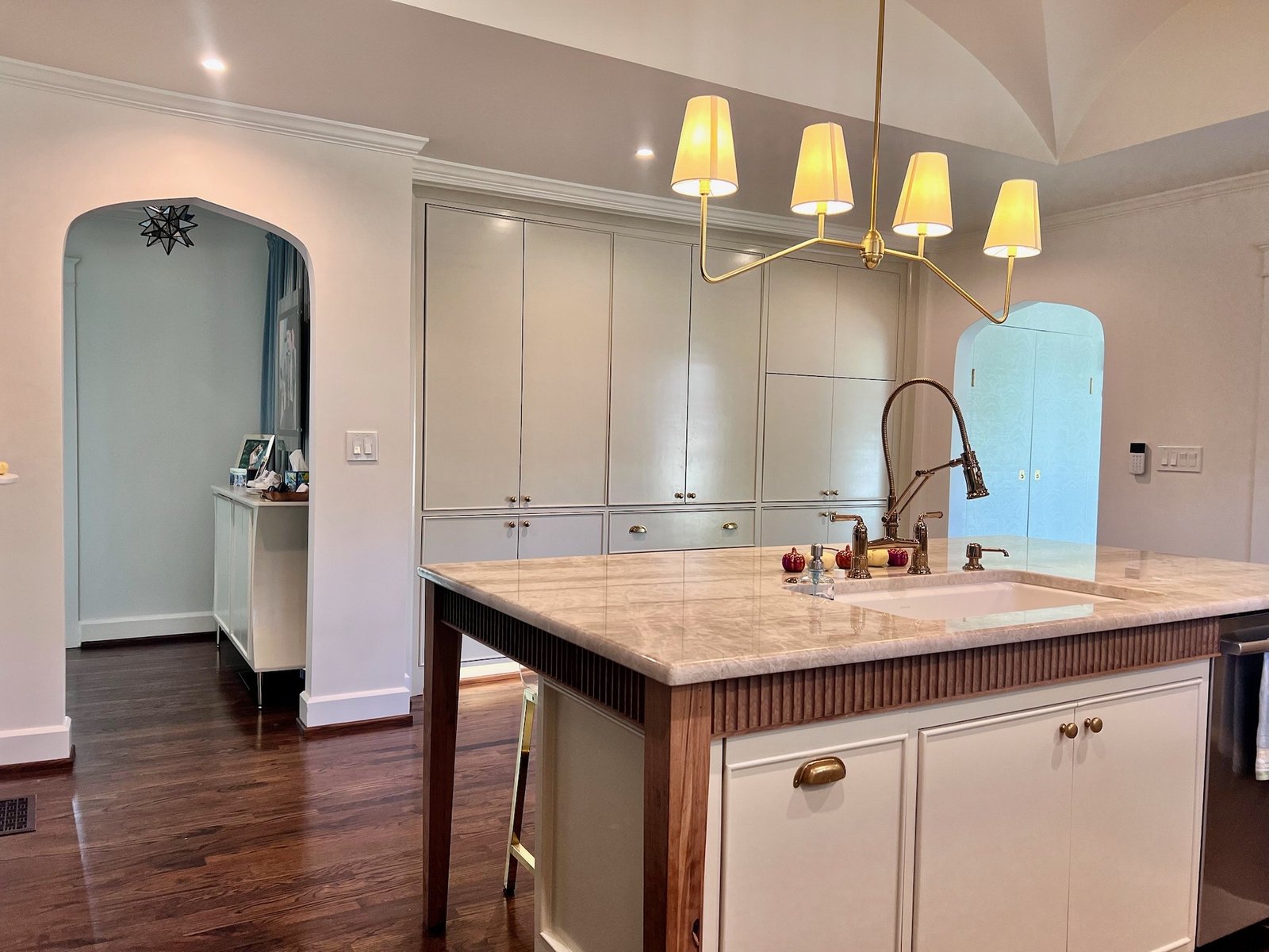 Kitchen with island, pendant lighting and cabinet storage